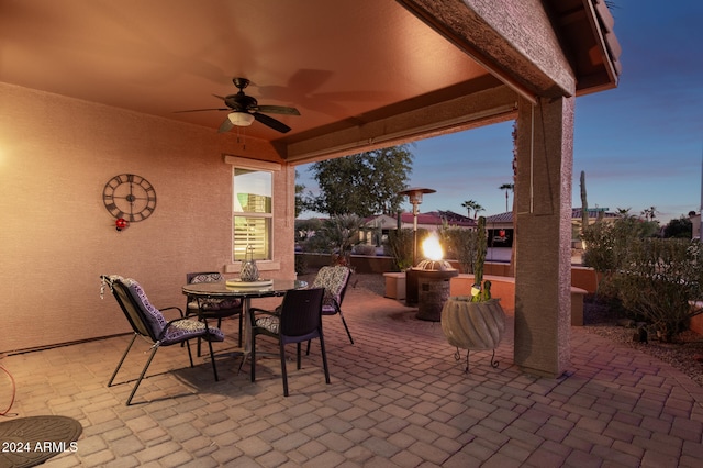 patio terrace at dusk featuring ceiling fan