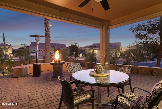 patio terrace at dusk featuring ceiling fan