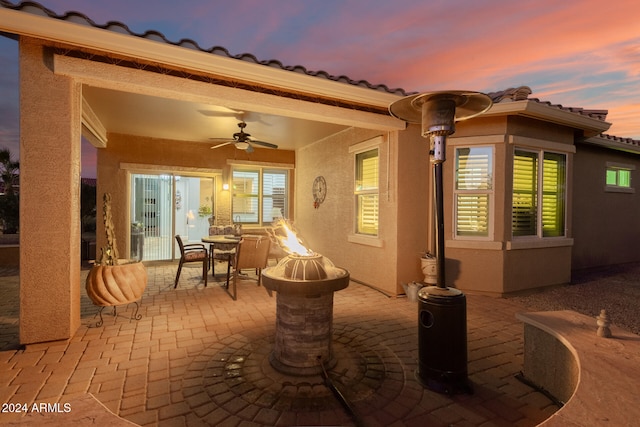 patio terrace at dusk featuring ceiling fan