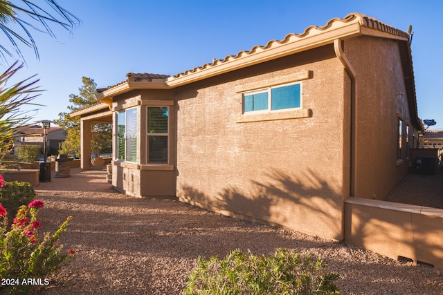 view of side of home with a patio