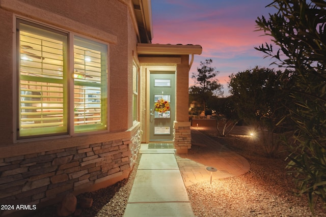 exterior entry at dusk with a patio area