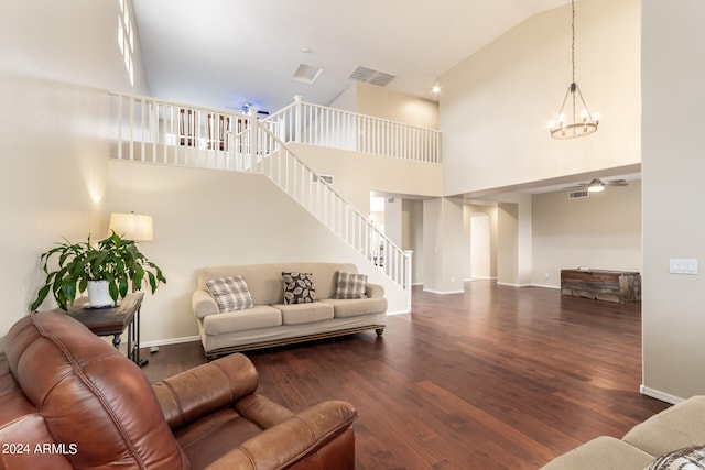 living room featuring high vaulted ceiling, dark hardwood / wood-style flooring, and a notable chandelier