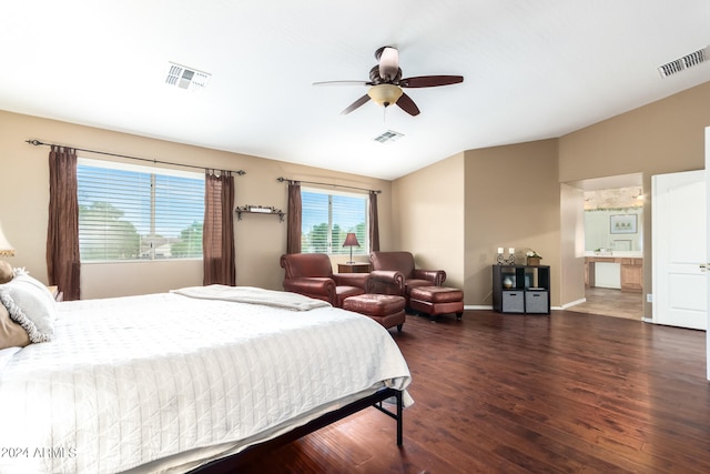 bedroom featuring lofted ceiling, ceiling fan, dark hardwood / wood-style floors, and ensuite bath