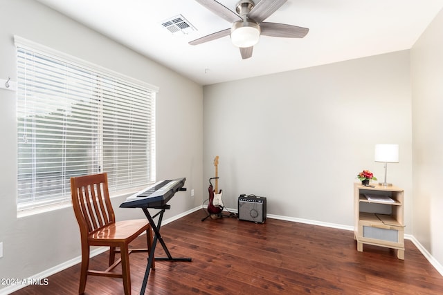 home office featuring dark wood-type flooring and ceiling fan