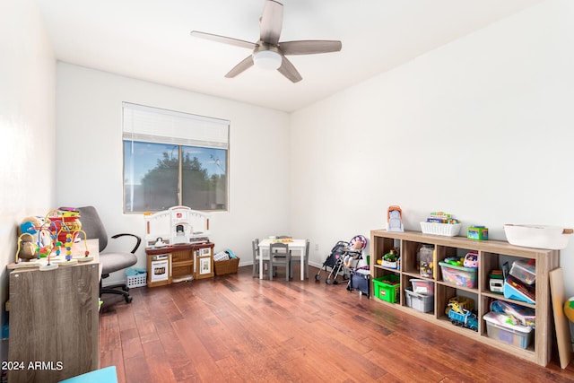 playroom with dark hardwood / wood-style flooring and ceiling fan