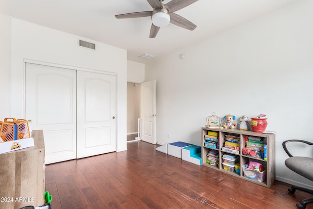 recreation room featuring ceiling fan and dark hardwood / wood-style floors