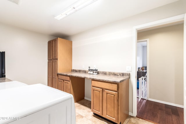 kitchen featuring washer and clothes dryer and light hardwood / wood-style floors