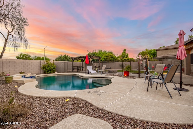 pool at dusk with a patio