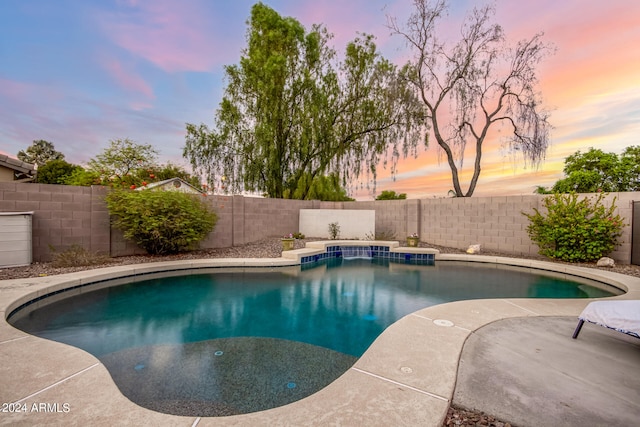 view of pool at dusk