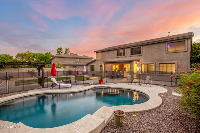 pool at dusk with a patio