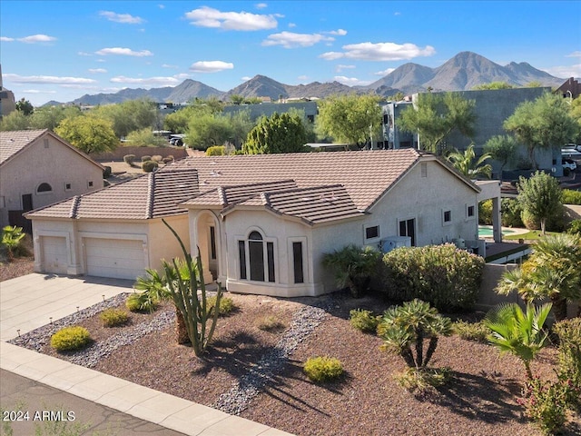 view of front of home with a mountain view and a garage