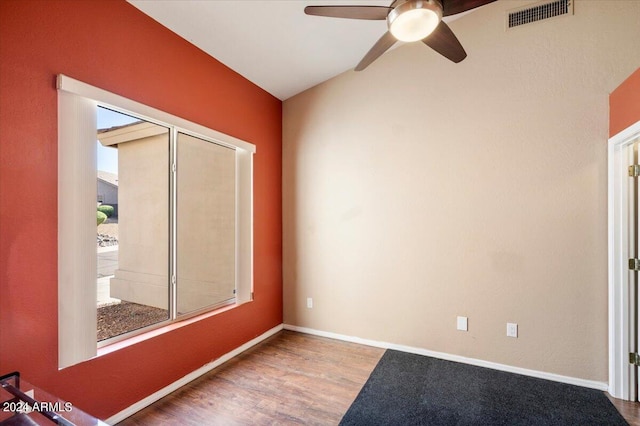 spare room with ceiling fan, hardwood / wood-style flooring, and lofted ceiling