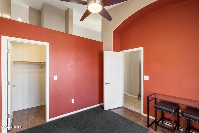 bedroom with a spacious closet, ceiling fan, a closet, and hardwood / wood-style floors