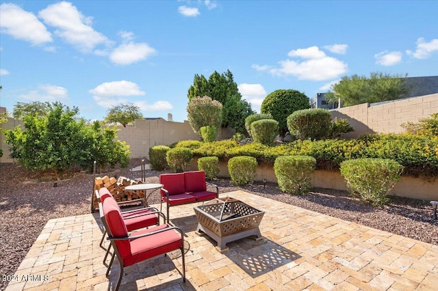 view of patio featuring an outdoor living space with a fire pit