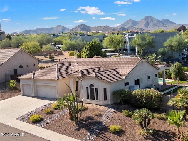 view of front of house with a mountain view and a garage