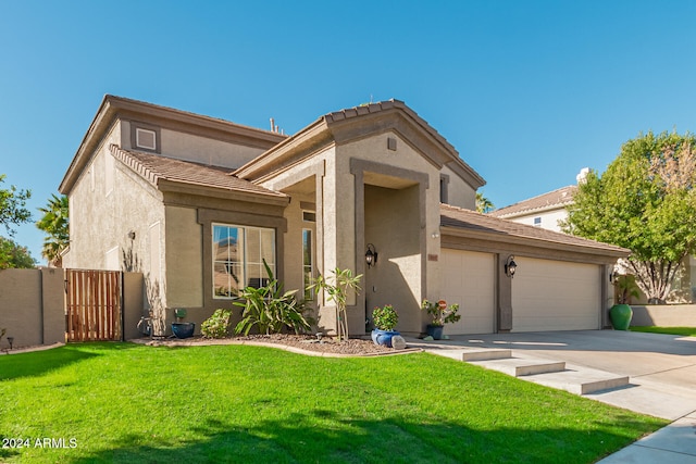 view of front of home with a front yard and a garage