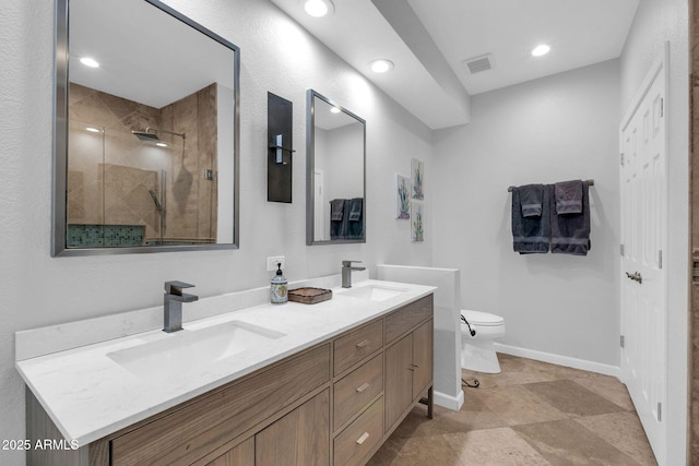 bathroom featuring vanity, an enclosed shower, and toilet