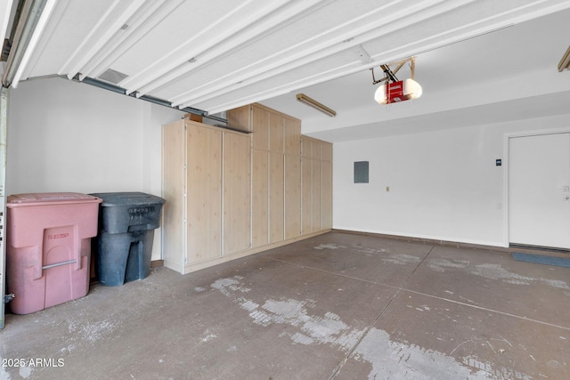 garage with a garage door opener and electric panel