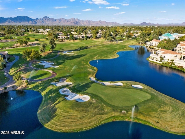 birds eye view of property with a water and mountain view