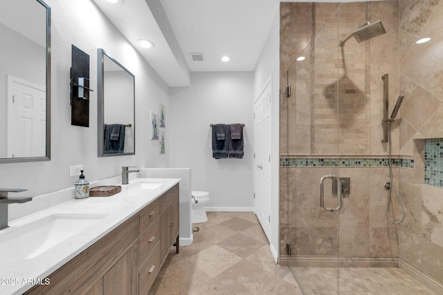 bathroom featuring vanity, a shower with shower door, and toilet