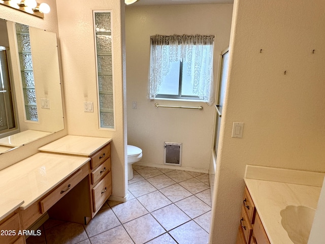 full bathroom with tile patterned floors, vanity, and toilet