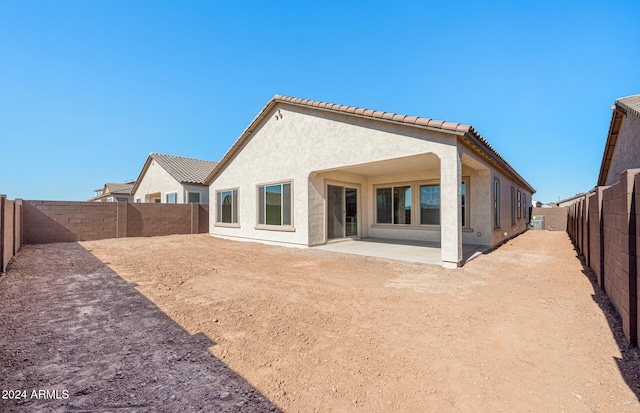 rear view of property featuring a patio area