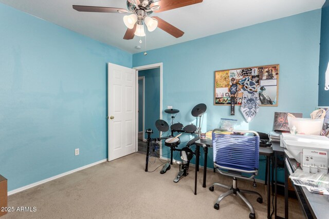 carpeted office featuring ceiling fan