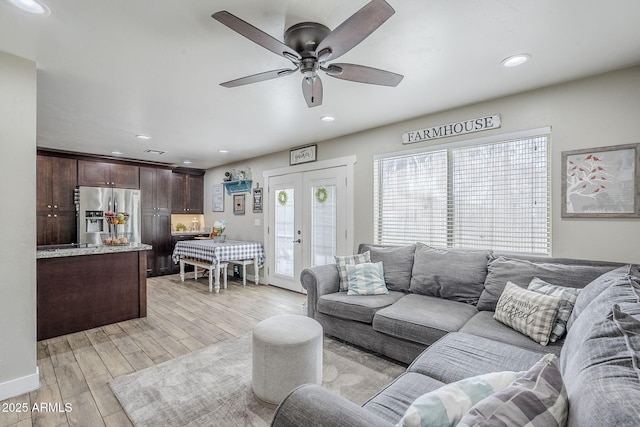 living room with recessed lighting, light wood-type flooring, a ceiling fan, and french doors