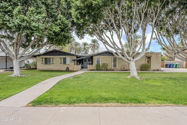 single story home with brick siding and a front lawn