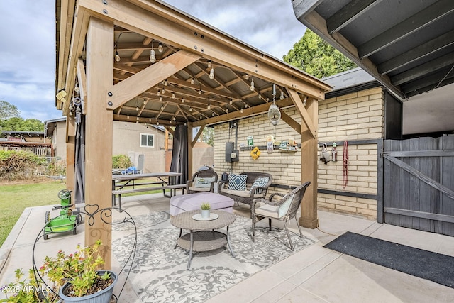 view of patio / terrace with an outdoor living space, a gazebo, and fence