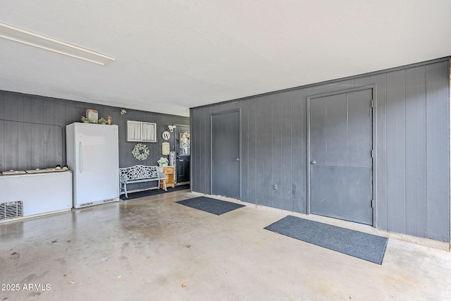 garage with freestanding refrigerator