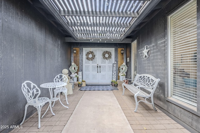 doorway to property with a pergola