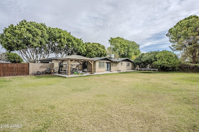 view of yard with a gazebo, a fenced backyard, a patio area, and a trampoline