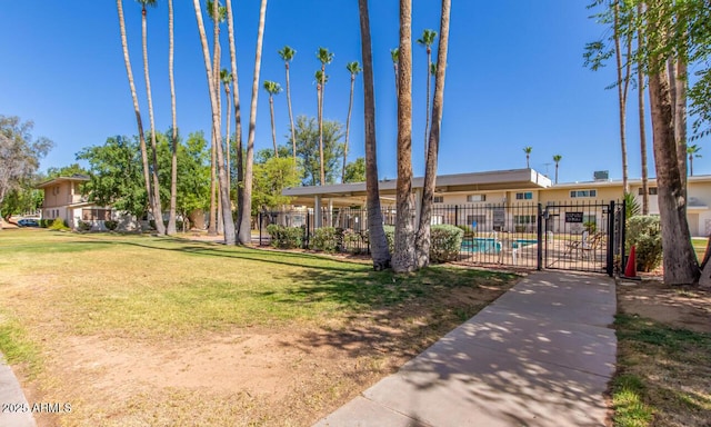 ranch-style home with a front yard and a community pool