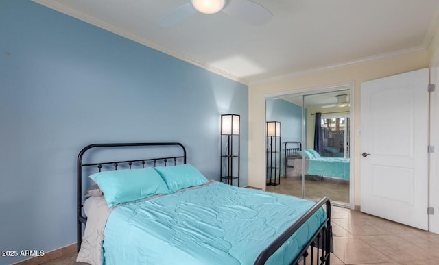 tiled bedroom featuring crown molding, ceiling fan, and a closet