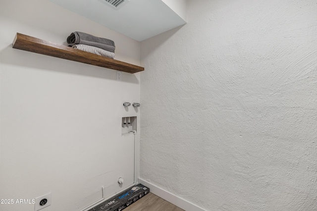 clothes washing area featuring hookup for a washing machine, wood finished floors, visible vents, hookup for an electric dryer, and laundry area