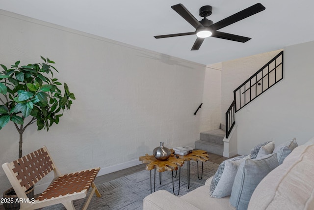 living room featuring stairs, ceiling fan, and wood finished floors