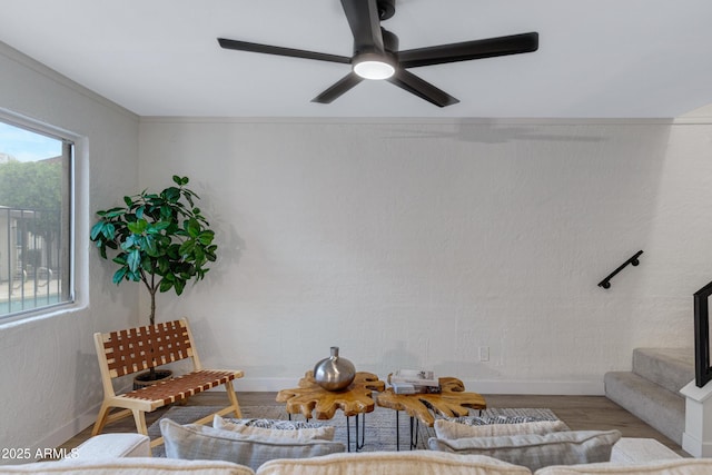 living room with stairs, wood finished floors, baseboards, and a ceiling fan