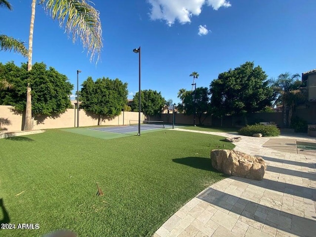 view of home's community with tennis court