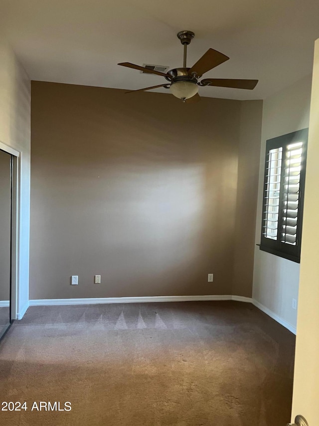 carpeted empty room with ceiling fan