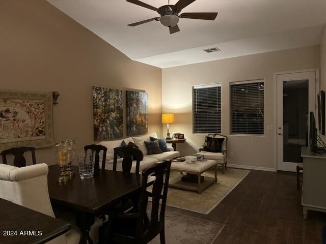 dining area with vaulted ceiling, ceiling fan, and dark hardwood / wood-style flooring