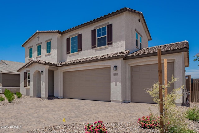 12362 W Marguerite Ave, Avondale, AZ 85323 - mediterranean / spanish house featuring a tiled roof, a garage, stucco siding, and decorative driveway
