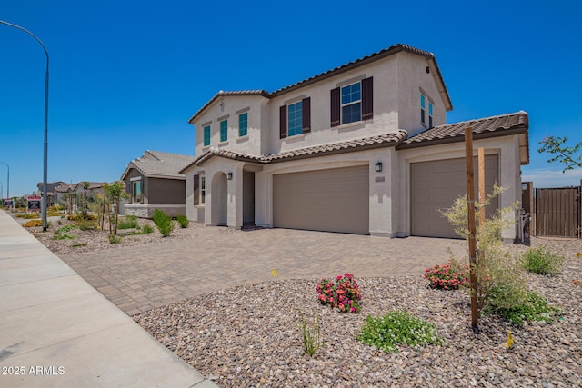 12362 W Marguerite Ave, Avondale, AZ 85323 - mediterranean / spanish-style home featuring a tile roof, stucco siding, decorative driveway, and a garage