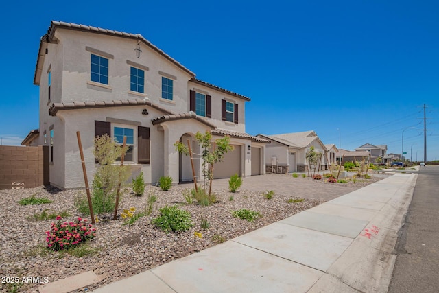 12362 W Marguerite Ave, Avondale, AZ 85323 - mediterranean / spanish-style house featuring a tile roof, driveway, an attached garage, stucco siding, and a residential view