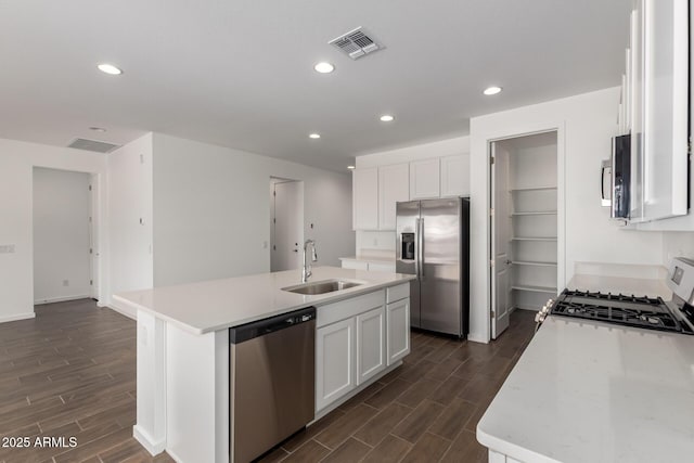 12362 W Marguerite Ave, Avondale, AZ 85323 - kitchen with stainless steel appliances, dark wood finished floors, white cabinetry, a kitchen island with sink, and recessed lighting