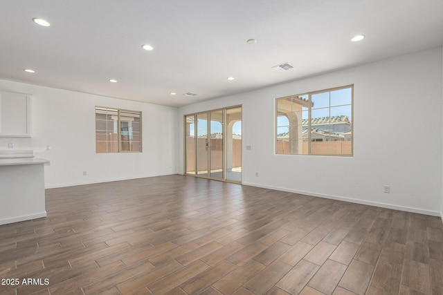 12362 W Marguerite Ave, Avondale, AZ 85323 - unfurnished living room featuring dark wood-style floors and recessed lighting