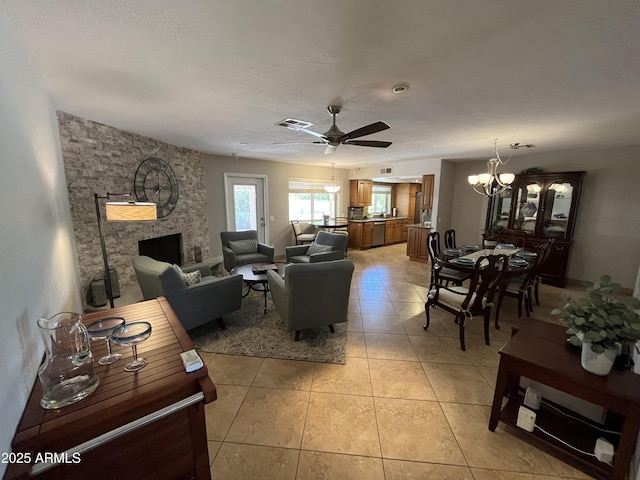 8355 E Via De Encanto, Scottsdale, AZ 85258 - living area with a chandelier, a ceiling fan, light tile patterned floors, and a stone fireplace