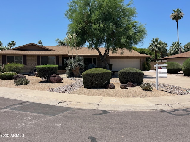 8355 E Via De Encanto, Scottsdale, AZ 85258 - ranch-style home featuring an attached garage, brick siding, and concrete driveway