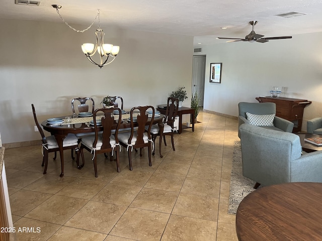 8355 E Via De Encanto, Scottsdale, AZ 85258 - dining room featuring a chandelier, light tile patterned floors, and a ceiling fan