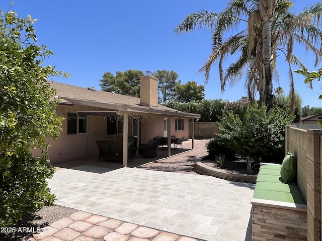 8355 E Via De Encanto, Scottsdale, AZ 85258 - back of house with a fenced backyard, a chimney, a patio area, an outdoor hangout area, and stucco siding